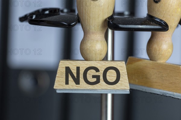 Stamp with added text NGO on a desk (symbolic image)
