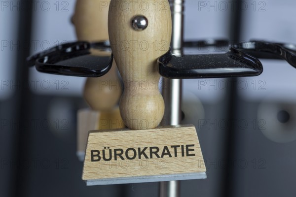 Stamp with added text BÃœROKRATIE on a desk (symbolic image)