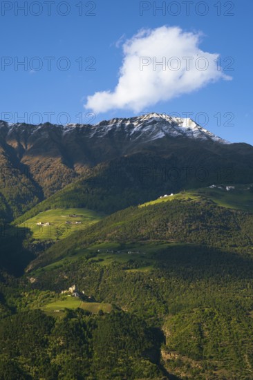 View of the Sonnenberg with Annenberg Castle and the farms above in the evening light, Dolomites, South Tyrol, mountains, Laces, Morter, Italy
