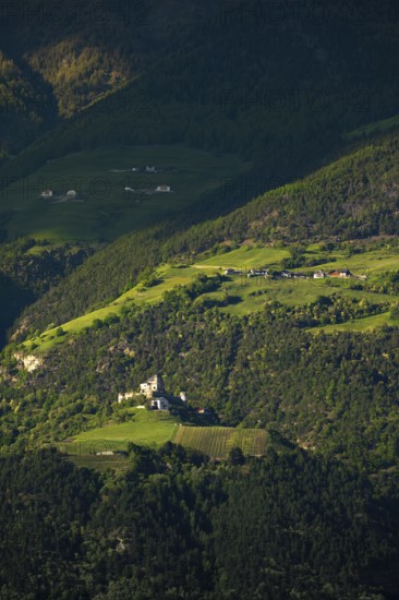 View of the Sonnenberg with Annenberg Castle and the farms above in the evening light, Dolomites, South Tyrol, mountains, Laces, Morter, Venosta Valley, Italy