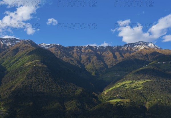 View of the Sonnenberg with Annenberg Castle and the farms above in the evening light, Dolomites, South Tyrol, mountains, Laces, Morter, Venosta Valley, Italy