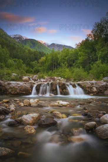 View of a waterfall of the Rio Plima stream in the evening light, long exposure, landscape photo, nature photo, portrait format, forest, trees, Dolomites, South Tyrol, mountains, Laces, Morter, Italy