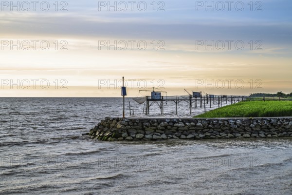 Sunset over Fishing huts over Gironde Estuary, Braud-et-Saint-Louis, France