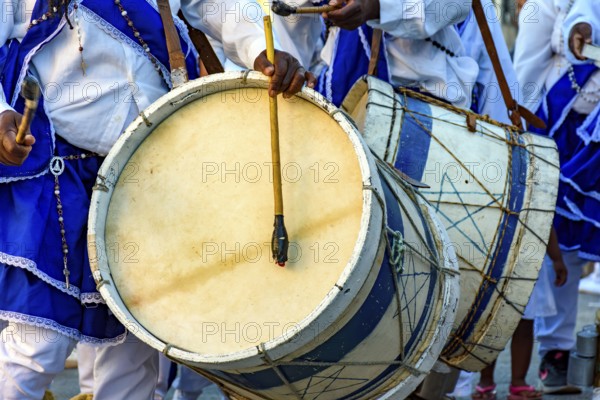 Musicians with their rustic wooden drums and colorful clothes during the religious festival of Congado in Minas Gerais, Minas Gerais, Brazil