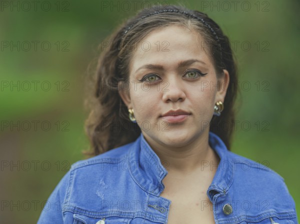 Portrait of attractive latin girl smiling outdoors. Close up of Latin American girl face looking and smiling at the camera
