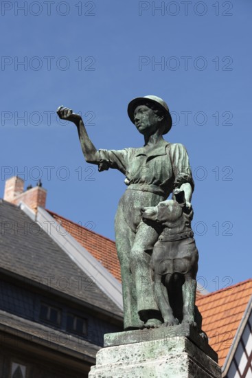 Symbolic statue of a young craftsman with a dog as a sign of civic freedom and loyalty in the World Heritage town, Quedlinburg, Saxony-Anhalt, Germany