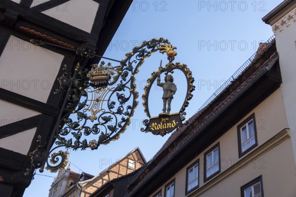 Traditional cantilever sign Zum Roland on a half-timbered house, Quedlinburg, Saxony-Anhalt, Germany