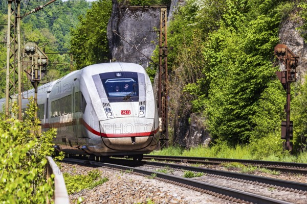 InterCityExpress ICE en route on the winding railway line of the Geislinger Steige. Landscape on the railway's Filstalline line in spring. Amstetten, Baden-WÃ¼rttemberg, Germany
