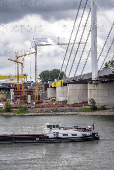 Rhine bridge Duisburg-Neuenkamp, the A40 motorway, start of construction of the second bridge, bridge piers and the first bridge segment are erected on the Neuenkamp side of the Rhine, cargo ship on the Rhine, North Rhine-Westphalia, Germany