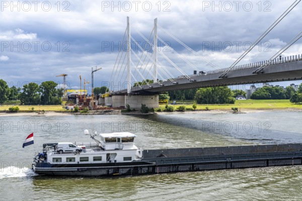 Rhine bridge Duisburg-Neuenkamp, the A40 motorway, start of construction of the second bridge, bridge piers and the first bridge segment are erected on the Neuenkamp side of the Rhine, cargo ship on the Rhine, with coal for a power station in Karlsruhe, North Rhine-Westphalia, Germany