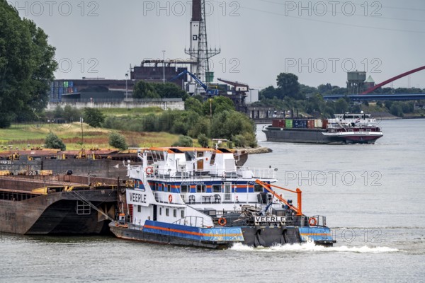 Cargo ships on the Rhine, in the background the Rhine bridge near Duisburg-Rheinhausen, Bridge of Solidarity, pushed convoy being assembled, Duisburg, North Rhine-Westphalia, Germany