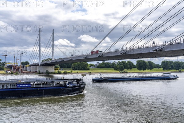 Rhine bridge Duisburg-Neuenkamp, the A40 motorway, start of construction of the second bridge, bridge piers and the first bridge segment are erected on the Neuenkamp side of the Rhine, cargo ship on the Rhine, North Rhine-Westphalia, Germany