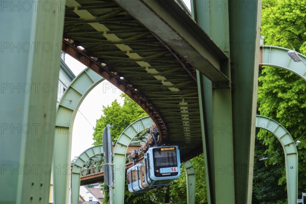 The Wuppertal suspension railway runs through Vohwinkel in front of buildings from the Wilhelminian era near the Hammerstein stop in Wuppertal, Germany