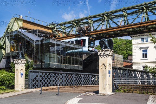 A suspension railway leaves the AdlerbrÃ¼cke stop, Wuppertal, Germany