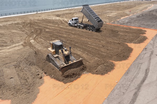 Detroit, Michigan - Workers spread clean dirt after old industrial contamination of cadmium, arsenic, lead, and other metals was removed from A.B. Ford Park on the Detroit River