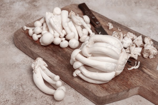 Freshly sliced Shimizhi mushrooms, on a wooden chopping board, ready to cook, close-up, no people