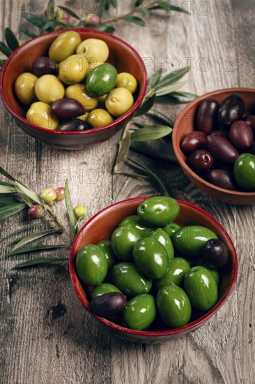 A mixture of olives, varieties of chalkidiki, Verdi giganti and Kalamata, in a bowl, top view, no people