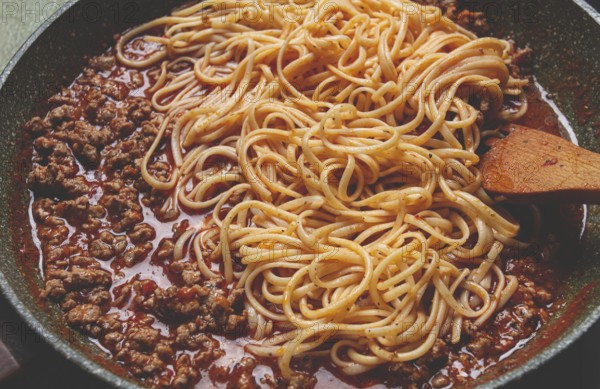 Spaghetti Bolognese, top view, in a frying pan, close-up, without people, homemade