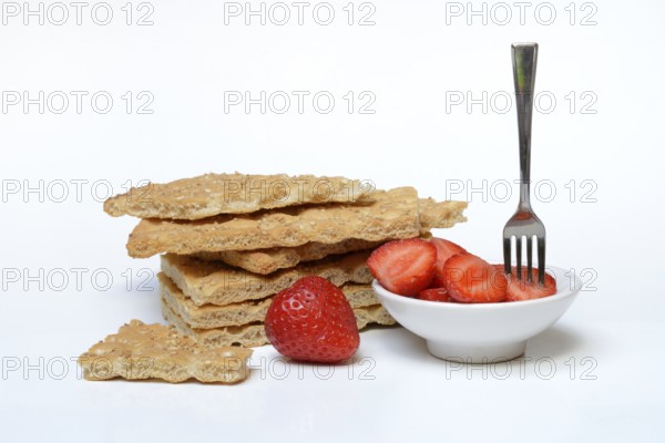 Crispbread and bowl of strawberries