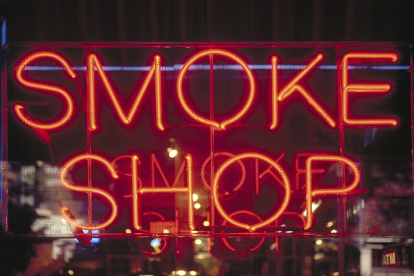 Illuminated advertising at a tobacco shop, Manhattan, New York City, USA
