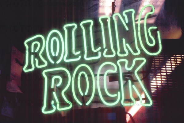 Illuminated advert for Rolling Rock beer at a bar, Manhattan, New York City, USA