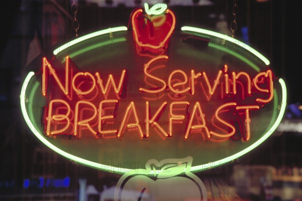Morning illuminated advertising at a restaurant, New York City, USA
