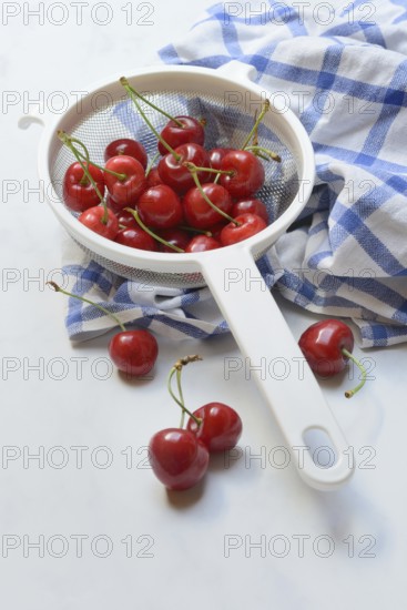 Sweet cherries in sieve, Prunus avium, bird cherry