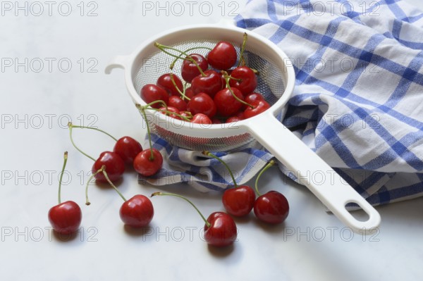 Sweet cherries in sieve, Prunus avium, bird cherry