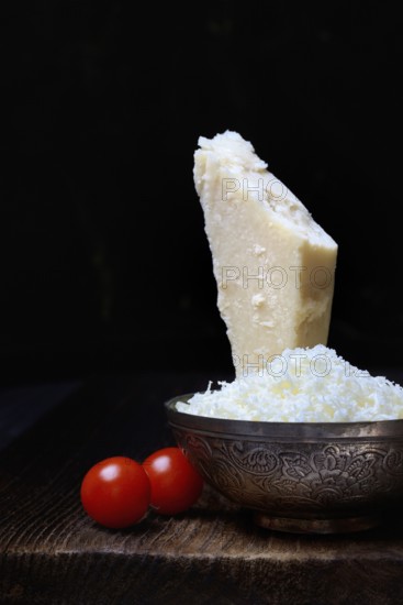 Parmesan cheese, grated cheese in rind and piece of Parmesan, Italy