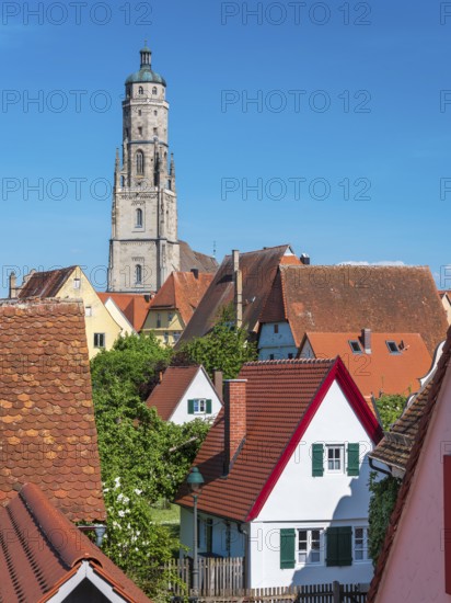 View from the medieval town wall over the houses of the historic old town to the tower of St George's Church, called Daniel, Nördlingen, Bavaria, Germany