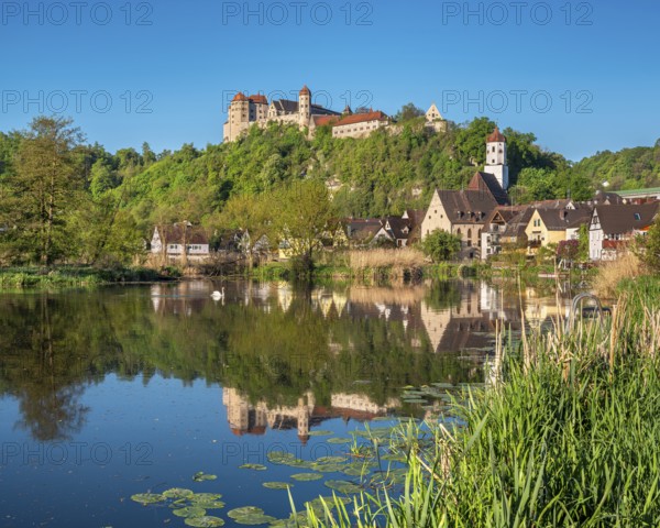 Castle and old town with St Barbara's Church and synagogue reflected in the River Wörnitz, Harburg, Donau-Ries, Swabia, Bavaria, Germany