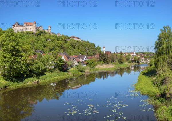 View over the river Wörnitz with water lilies to the castle and the old town with the churches of St Barbara and Herz Jesu, Harburg, Donau-Ries, Swabia, Bavaria, Germany