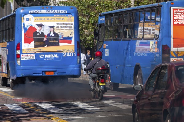 Buses in motion emitting pollution, City of Quito. Pichincha province, Ecuador, South America