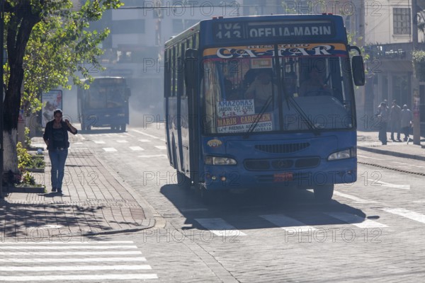 Bus in motion emitting pollution, City of Quito. Pichincha province, Ecuador, South America