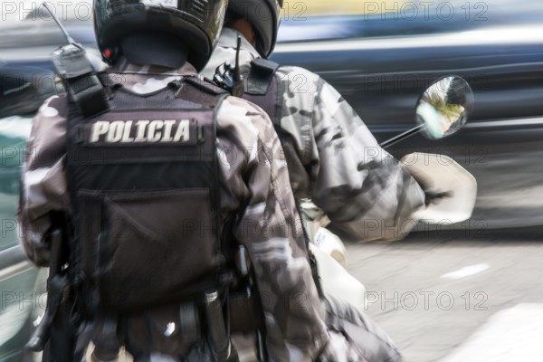 Policemen riding a motorcycle, Motion blur, City of Quito. Pichincha province, Ecuador, South America