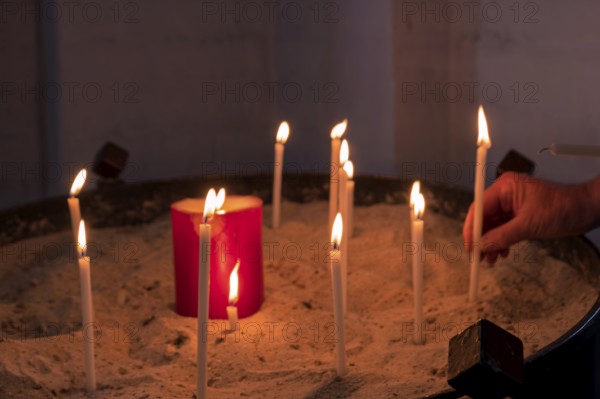 Sacrificial candles in a church, Stade, Lower Saxony, Germany