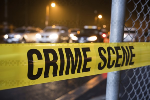 Close up of yellow crime scene tape in street with cars in blurry background. Generative ai, AI generated