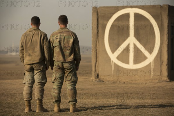 Two soldiers facing painted peace symbol on brick wall. Contrast between duty and hope in times of conflict. Generative Ai, AI generated
