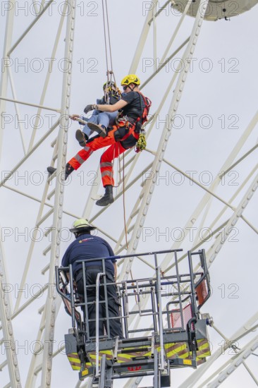 Fire brigade rescues person on Ferris wheel by abseiling, Fire brigade exercise for gondola rescue, Germany