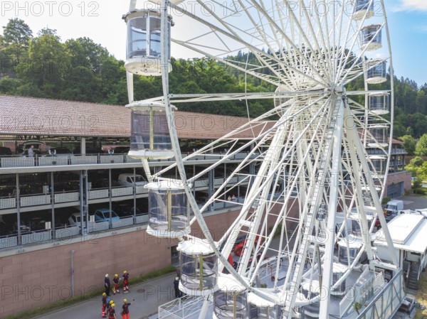 View of a Ferris wheel in a city, firefighters on site, fire brigade exercise for gondola rescue, Germany
