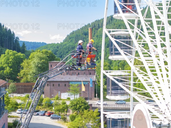 Fire brigade uses platform on Ferris wheel in a picturesque landscape, fire brigade exercise for gondola rescue, Germany