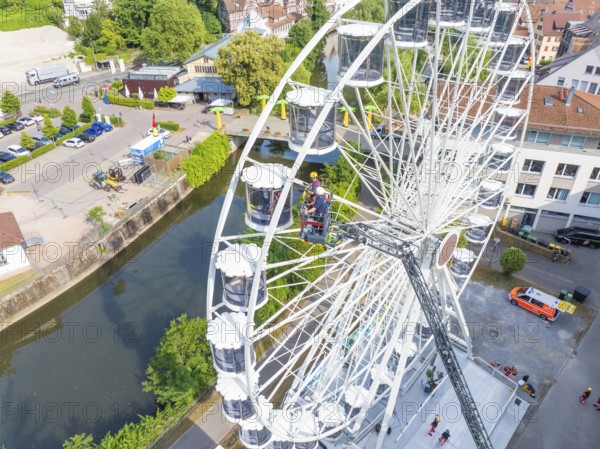 View from above of Ferris wheel and rescue operation in urban environment, fire brigade exercise for gondola rescue, Germany