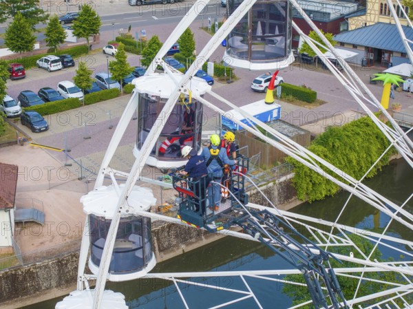 Fire brigade uses platform for rescue on Ferris wheel, Fire brigade exercise for gondola rescue, Germany