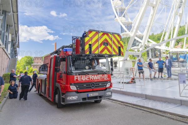 Fire brigade crew prepares operation on a Ferris wheel in front of a blue sky, Fire brigade exercise for gondola rescue Ferris wheel, Calw, Germany