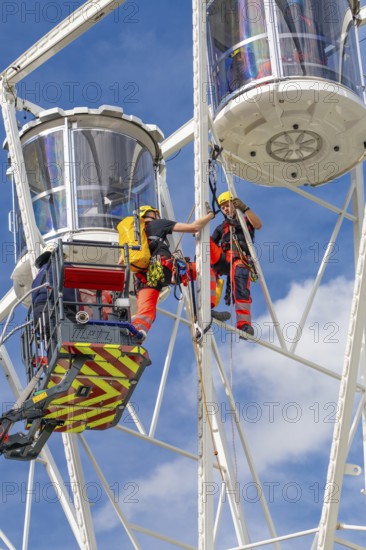 Firefighters on a rescue mission high up on a Ferris wheel, Fire brigade exercise for gondola rescue Ferris wheel, Calw, Germany