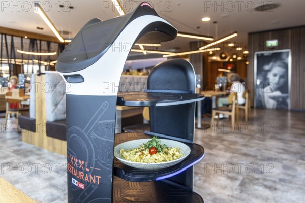 Furniture store XXXLutz Mann Mobilia Karlsruhe. In the restaurant, serving robot Lutzi supports the staff and brings the food to the table. Karlsruhe, Baden-WÃ¼rttemberg, Germany