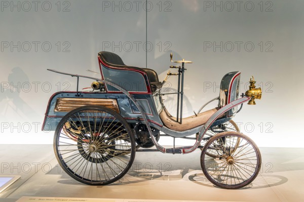 Benz Motor-Velociped Comfortable from 1898. The Mercedes-Benz Museum in Stuttgart presents a journey through the automotive history of the global corporation. The history of the Mercedes star begins with the first automobile in 1886. 160 vehicles are on display. Stuttgart, Baden-WÃ¼rttemberg, Germany