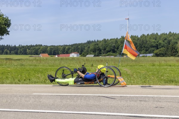 Man with handbike travelling on a country road. Special bike with manual drive for disabled people. Merklingen, Baden-WÃ¼rttemberg, Germany