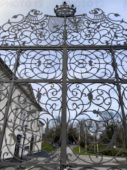 Wrought-iron Tor tor with ornaments and forged tendrils and stylised crown between Sclossgarten and former castle courtyard of Borbeck Castle historic summer residence of prince abbesses of Damenstift, Essen, North Rhine-Westphalia, Germany