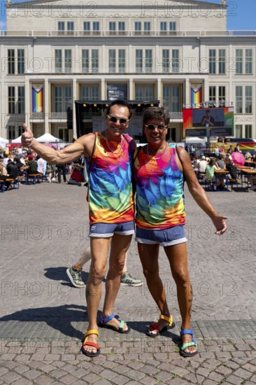 Two participants in the CSD colours, who also later carried the large Pride flag at Christopher Street Day in Leipzig on 28 June 2025